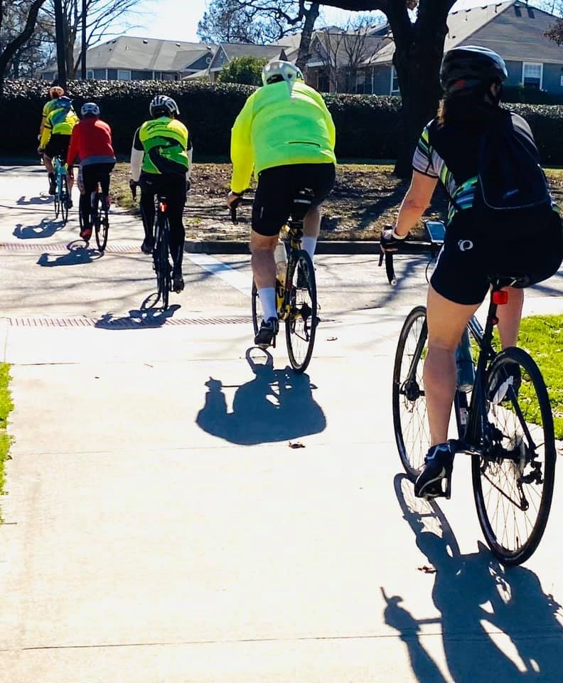 A group of people riding on the back of a bicycle

Description automatically generated